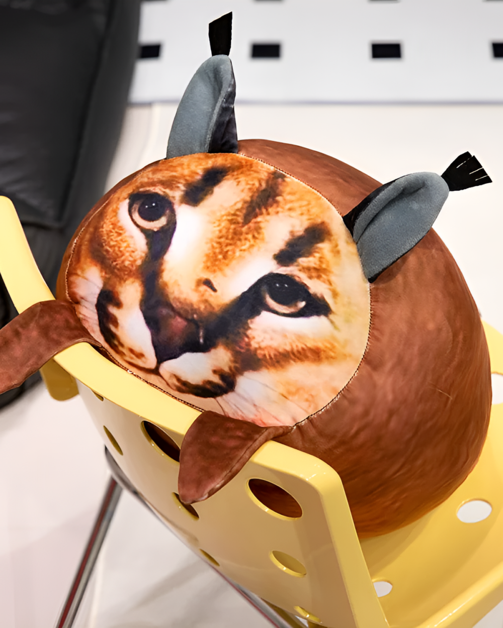 Close-up of a Chonky Big Floppa plushie with detailed printed face and ears.