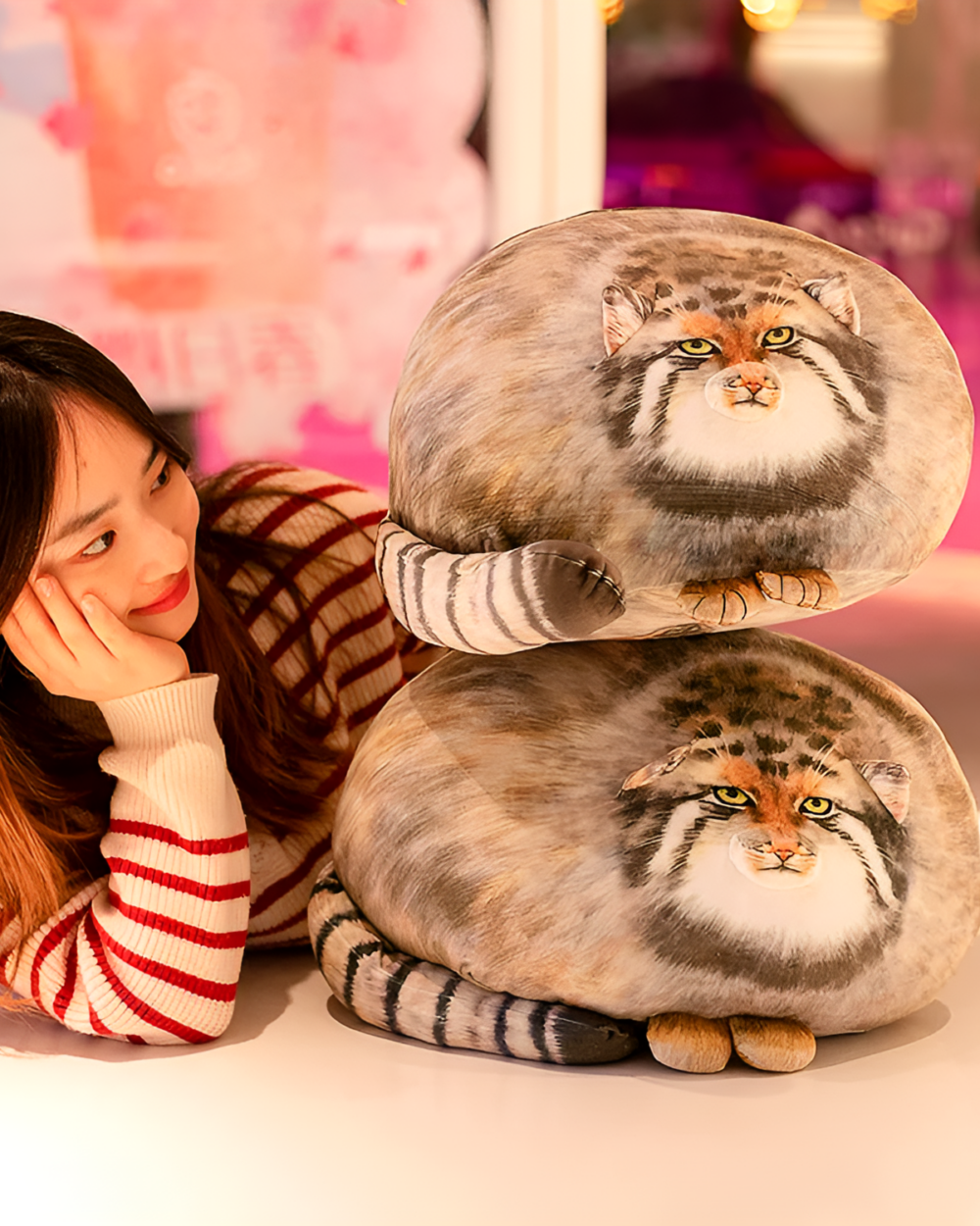 Chonky Realistic Palla's cat plush toy displayed with a person, showcasing its soft texture and design.