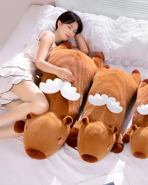 Woman sleeping with a large, brown Chonky Sleeping Capybara Plushie. Comfortable capybara plushie for cuddling and decoration.