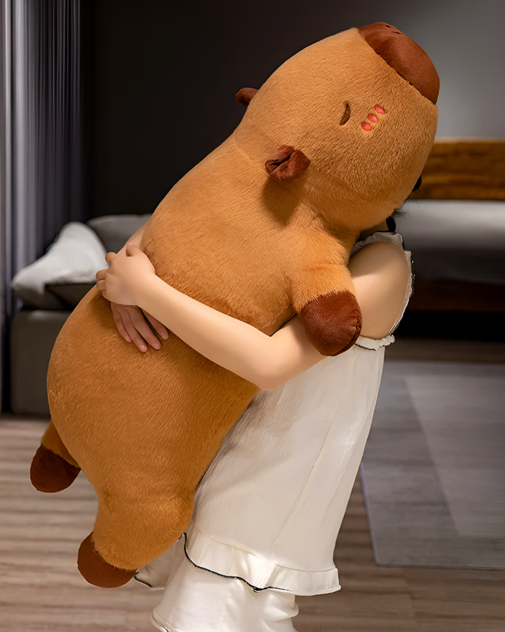 Person hugging a large, brown capybara plushie. The soft toy is a Chonky Sleeping Capybara Plushie.