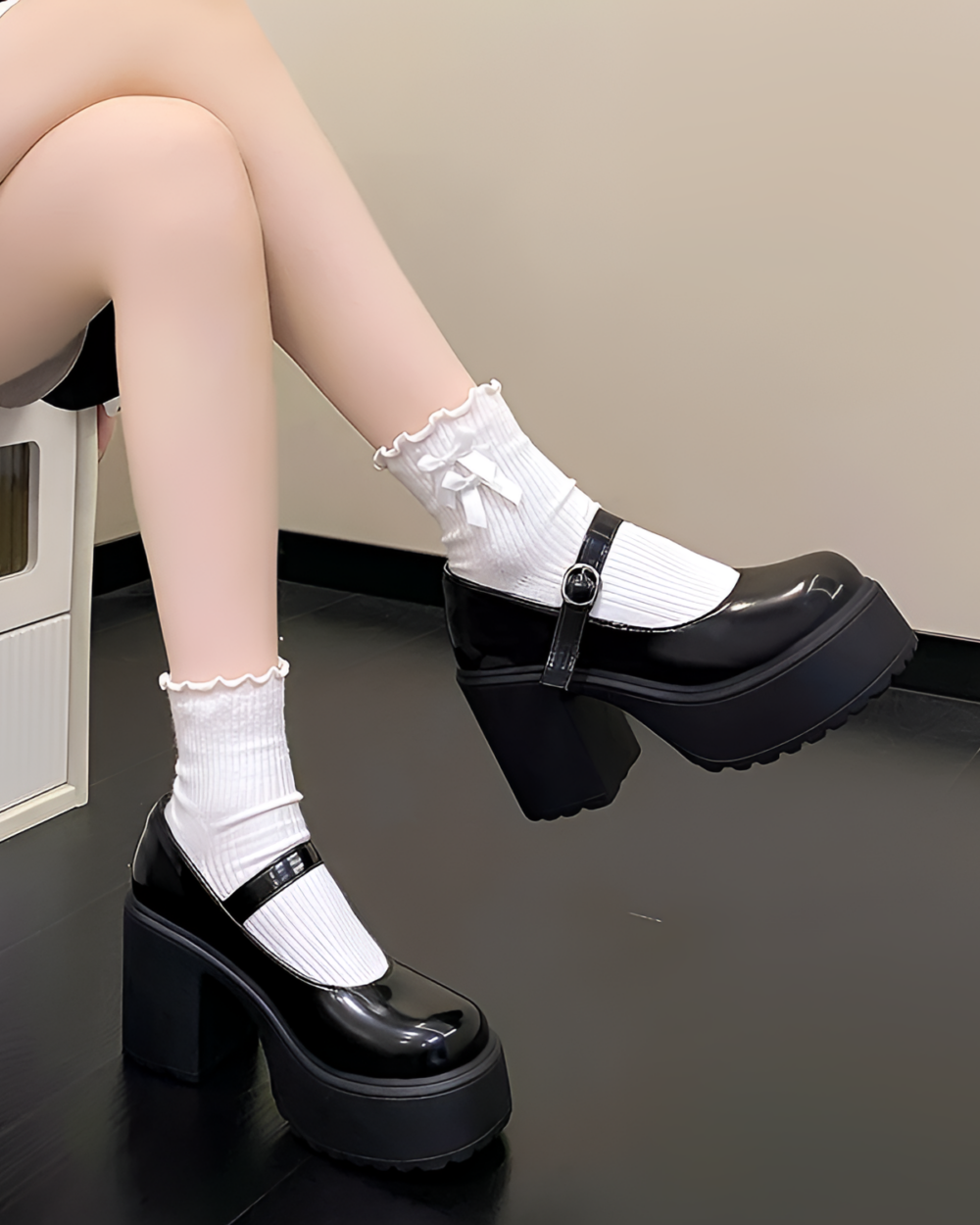 White chunky Mary Janes with a platform heel and ankle buckle. PU leather shoes, worn with white socks.