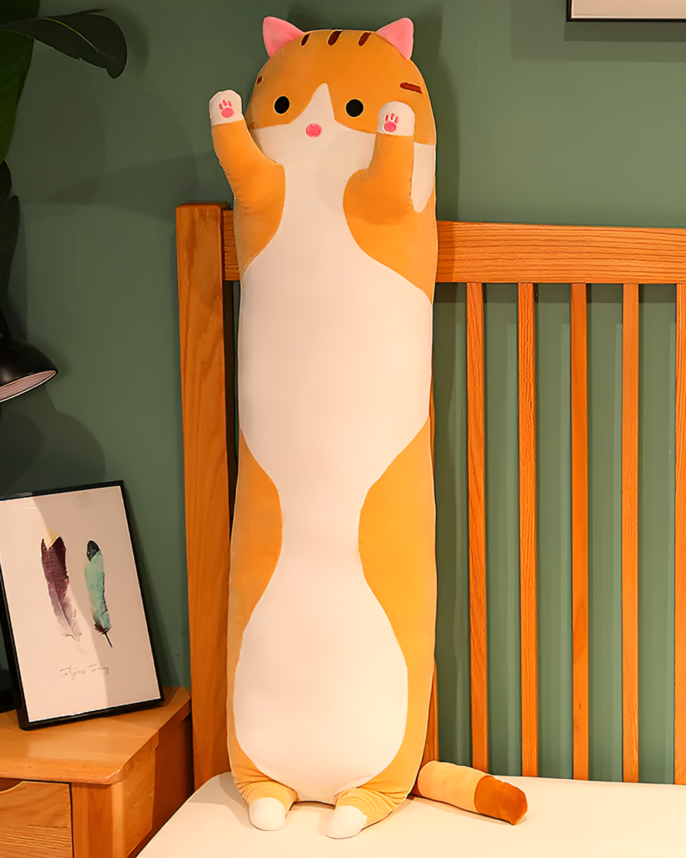 Orange and white long cat plush pillow. Ideal for snuggling, this Cloud Kitty pillow is a cute addition to any bedroom.
