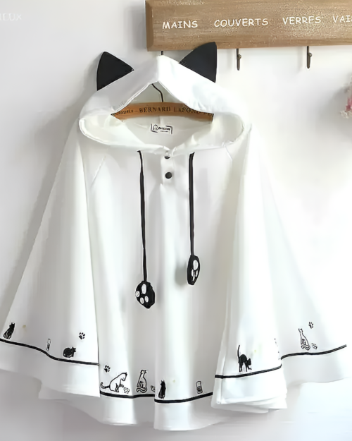 White neko ear poncho with cat paw and silhouette prints, featuring a hooded design. Comfortable and stylish outerwear.