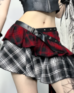 Crimson and black pleated goth punk skirt with a black belt featuring silver buckles. The skirt has a plaid pattern.