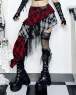 Crimson and black pleated goth punk skirt with layered design, fishnet stockings, and platform boots. A stylish aesthetic.