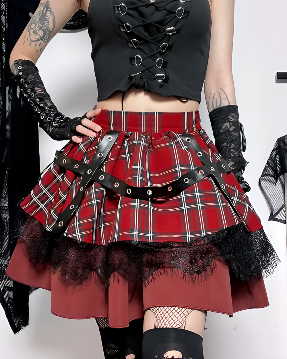 Crimson plaid goth punk skirt with black lace trim and harness details. Mini length, red and white checkered pattern.