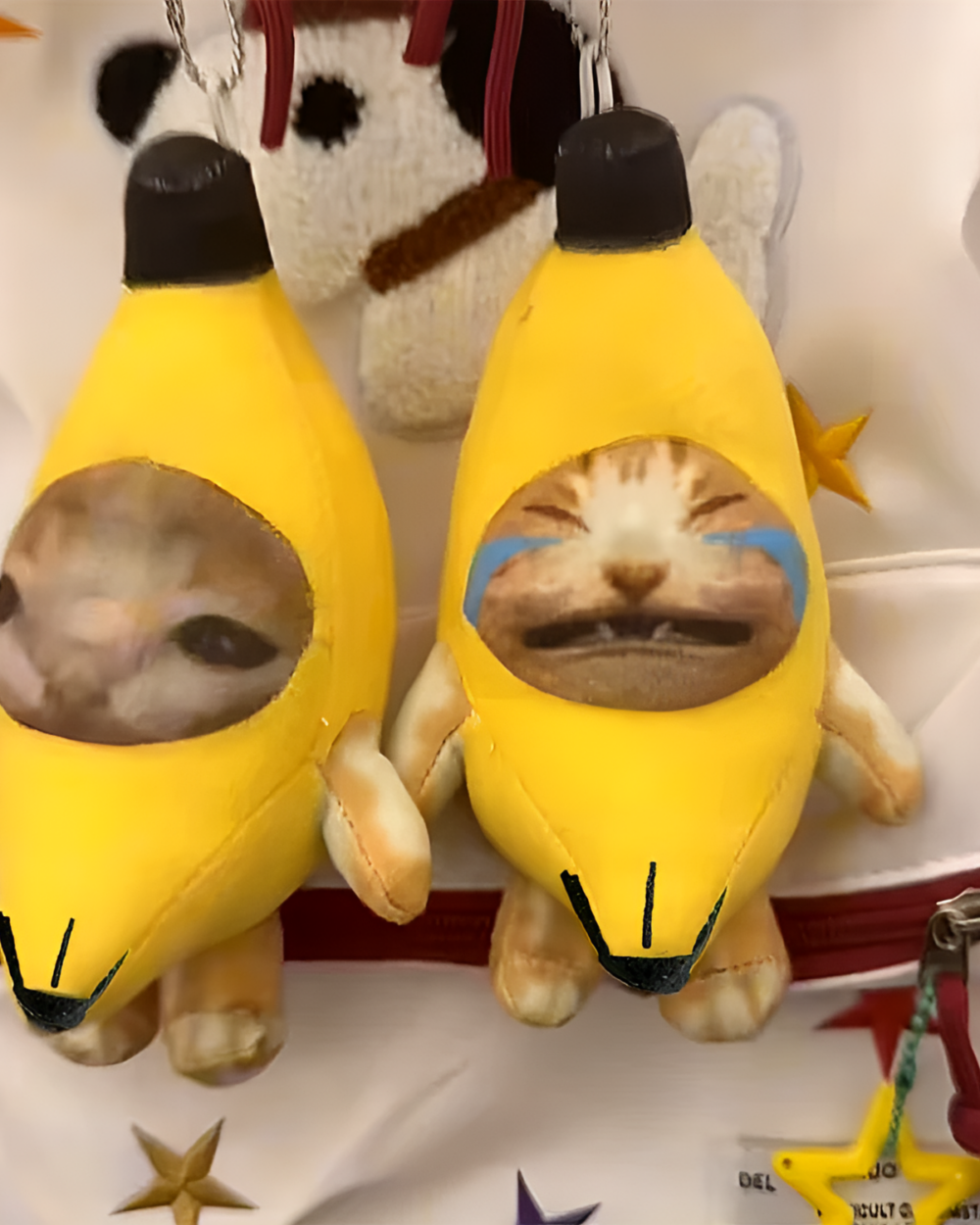 Crying Banana Cat bag charm featuring a plush banana with a sleeping cat face.