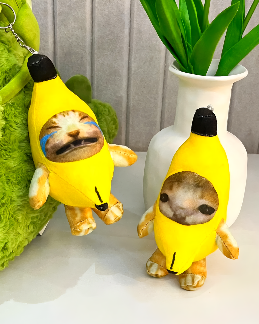 Crying Banana Cat bag charm featuring a plush cat inside a banana costume.