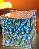 A DIY tulip lamp featuring blue LED lights illuminating beads inside a clear acrylic cube.
