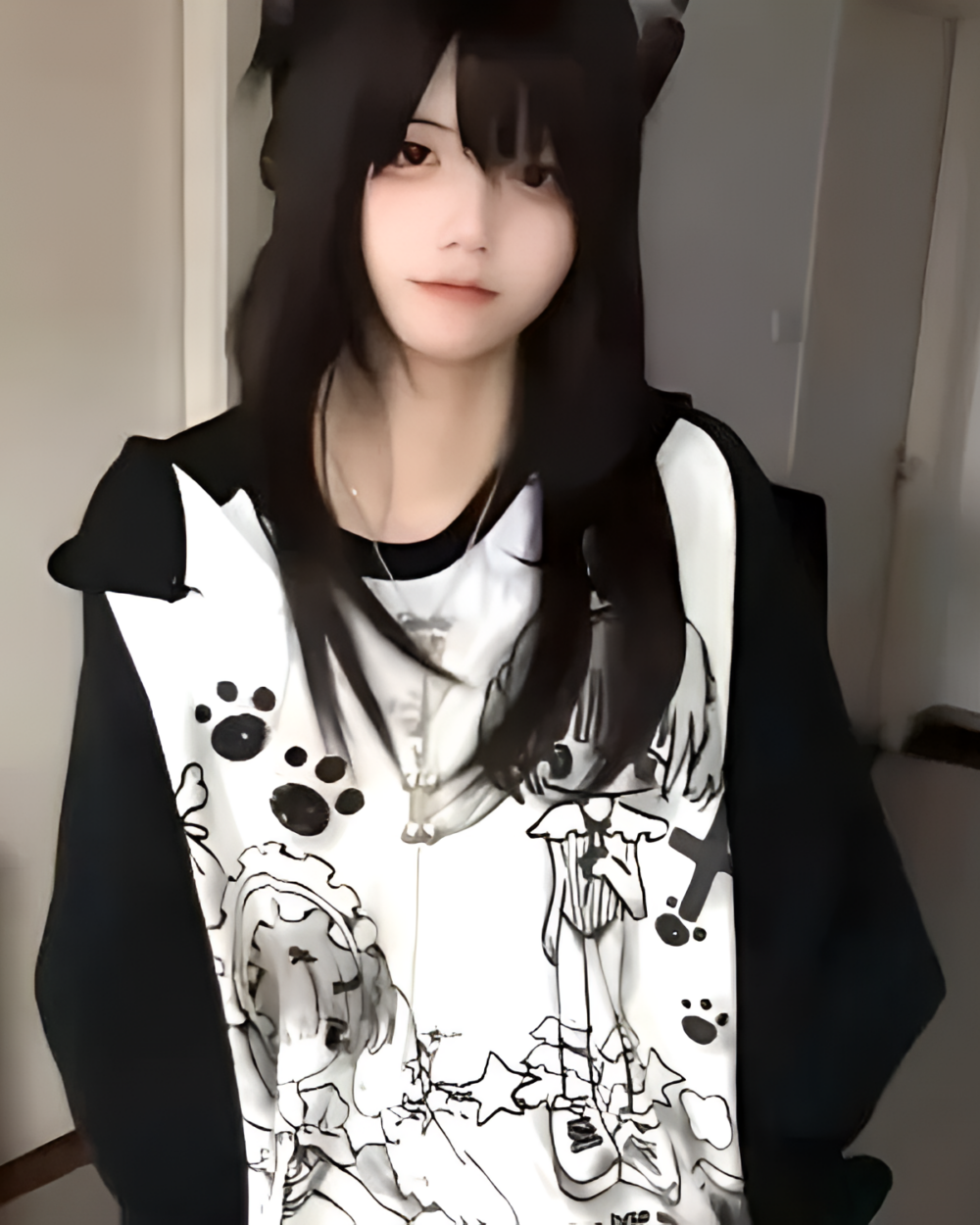 Person wearing a Dark Puppy Girl Hoodie featuring a print of cartoon dogs and paw prints.