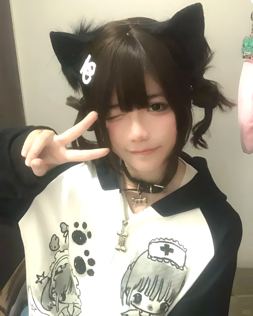 Person wearing a Dark Puppy Girl Hoodie featuring paw prints and a nurse design, with cat ears.