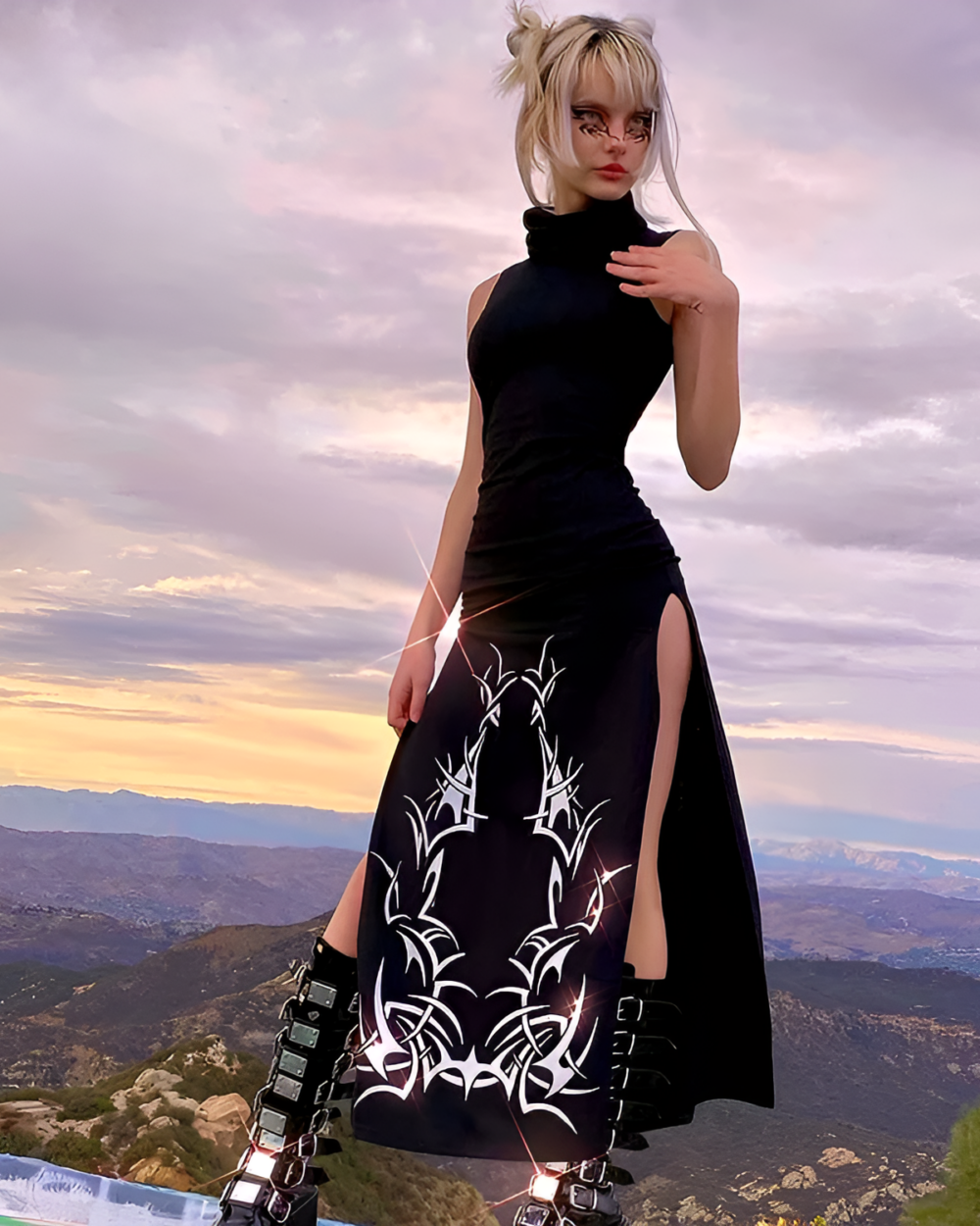 Woman wearing a black Dark Turtleneck Goth Dress with side slits and tribal print.