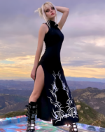 Model wearing a black Dark Turtleneck Goth Dress with tribal print details.