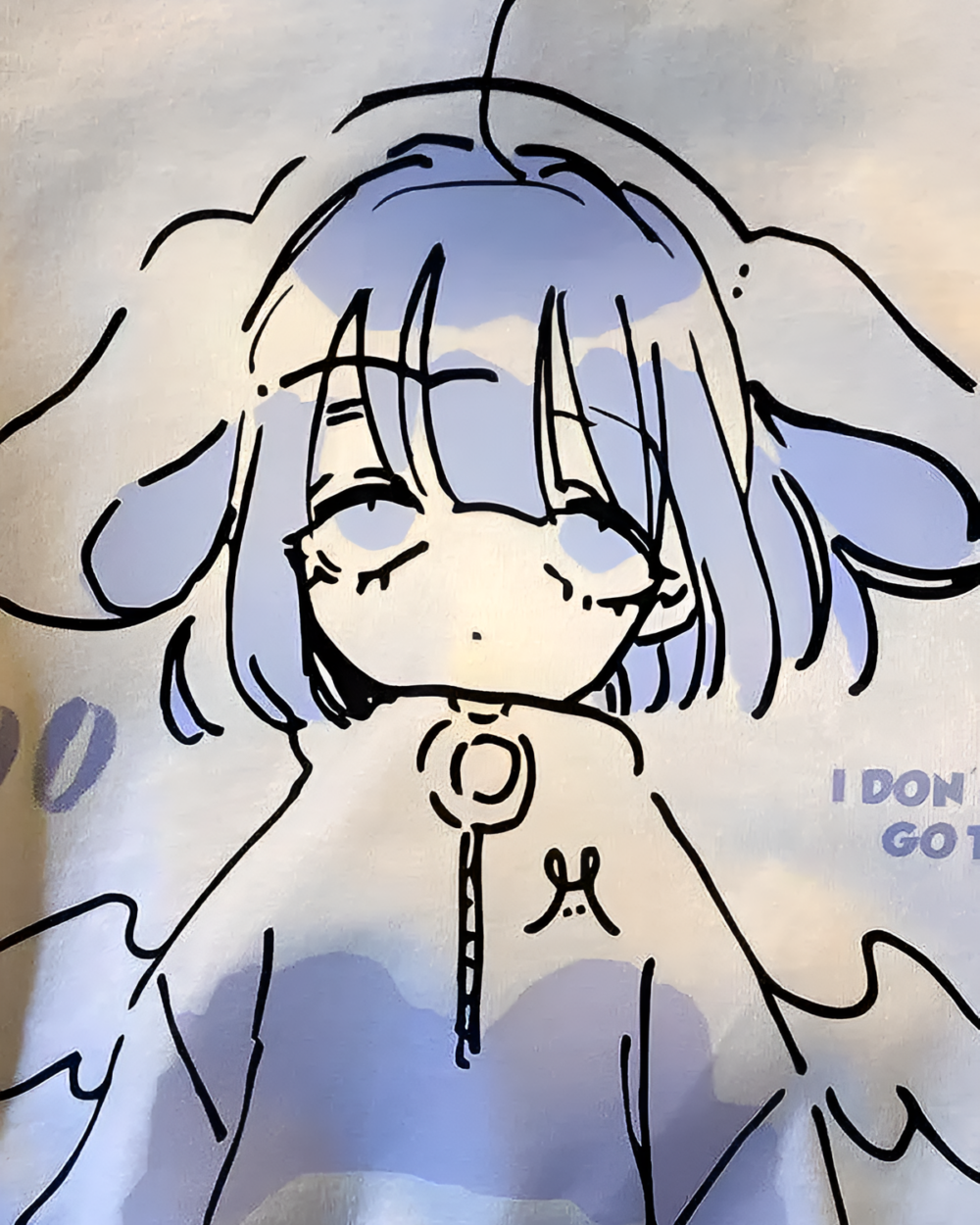 Close-up of a Drowsy Cherub Graphic Tee design featuring a line art illustration of a cherub against a blue background.