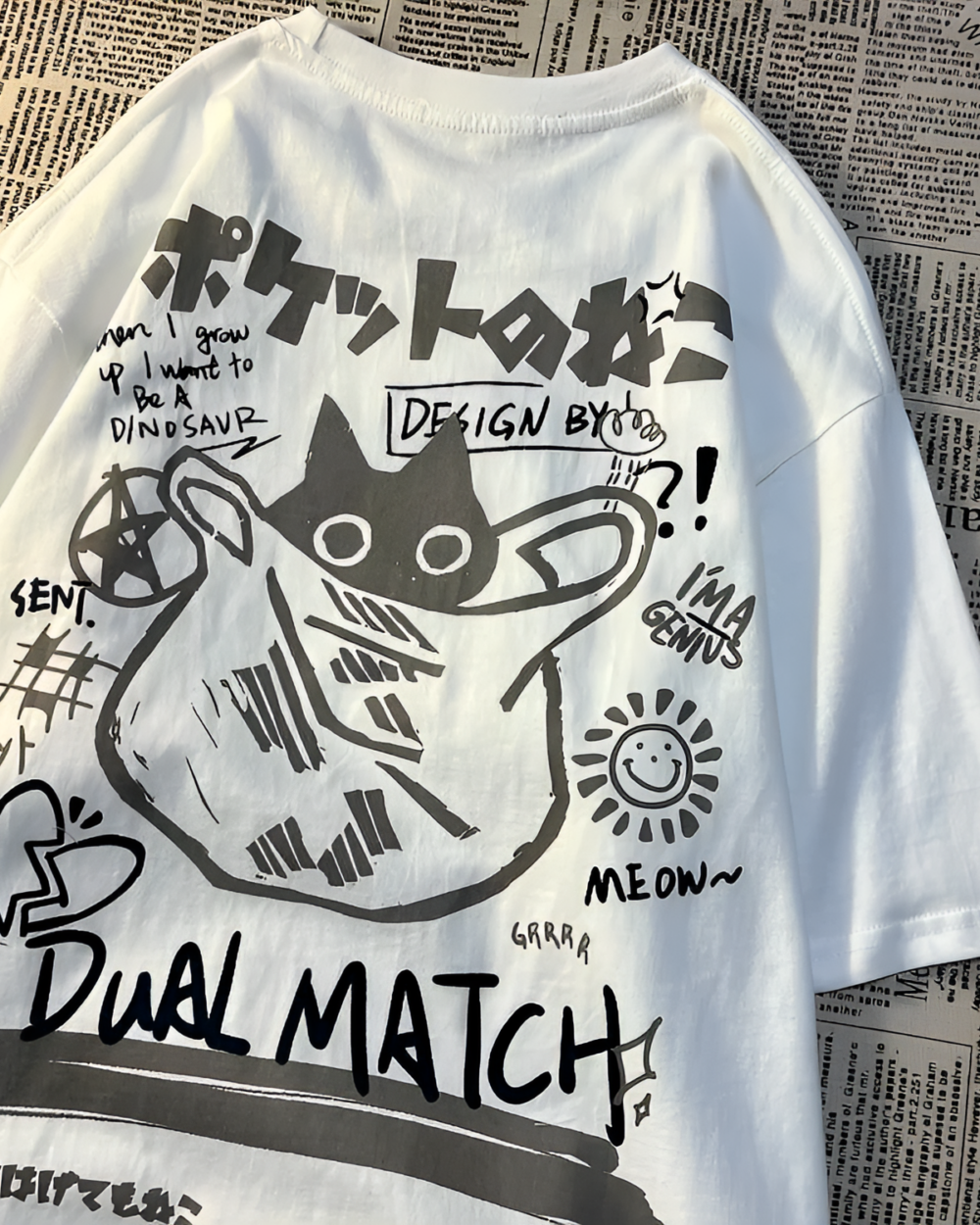 White t-shirt featuring a "Dual Match Neko Bag T-Shirt" design with cartoon illustrations and Japanese text.