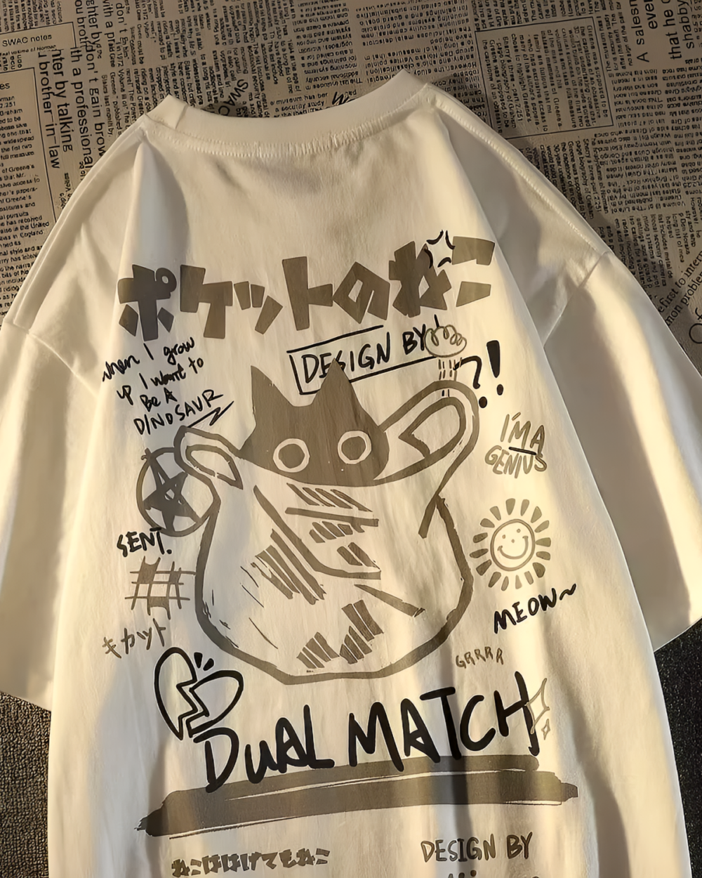 Close-up of a white Dual Match Neko Bag T-Shirt with a colorful graphic design featuring a cat and text.