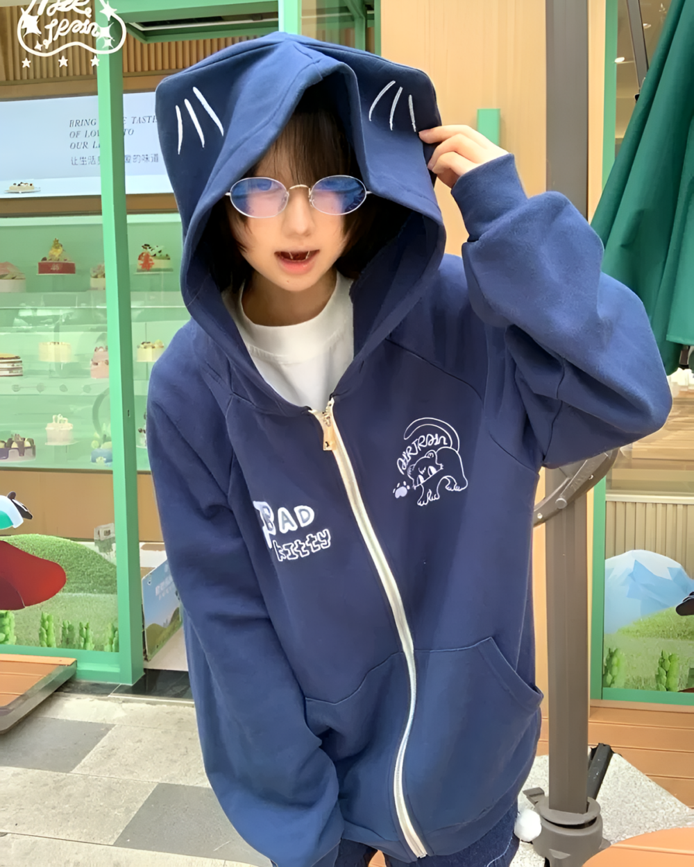 Dark blue Eared Hoodie featuring plush rabbit ears and a graphic design.