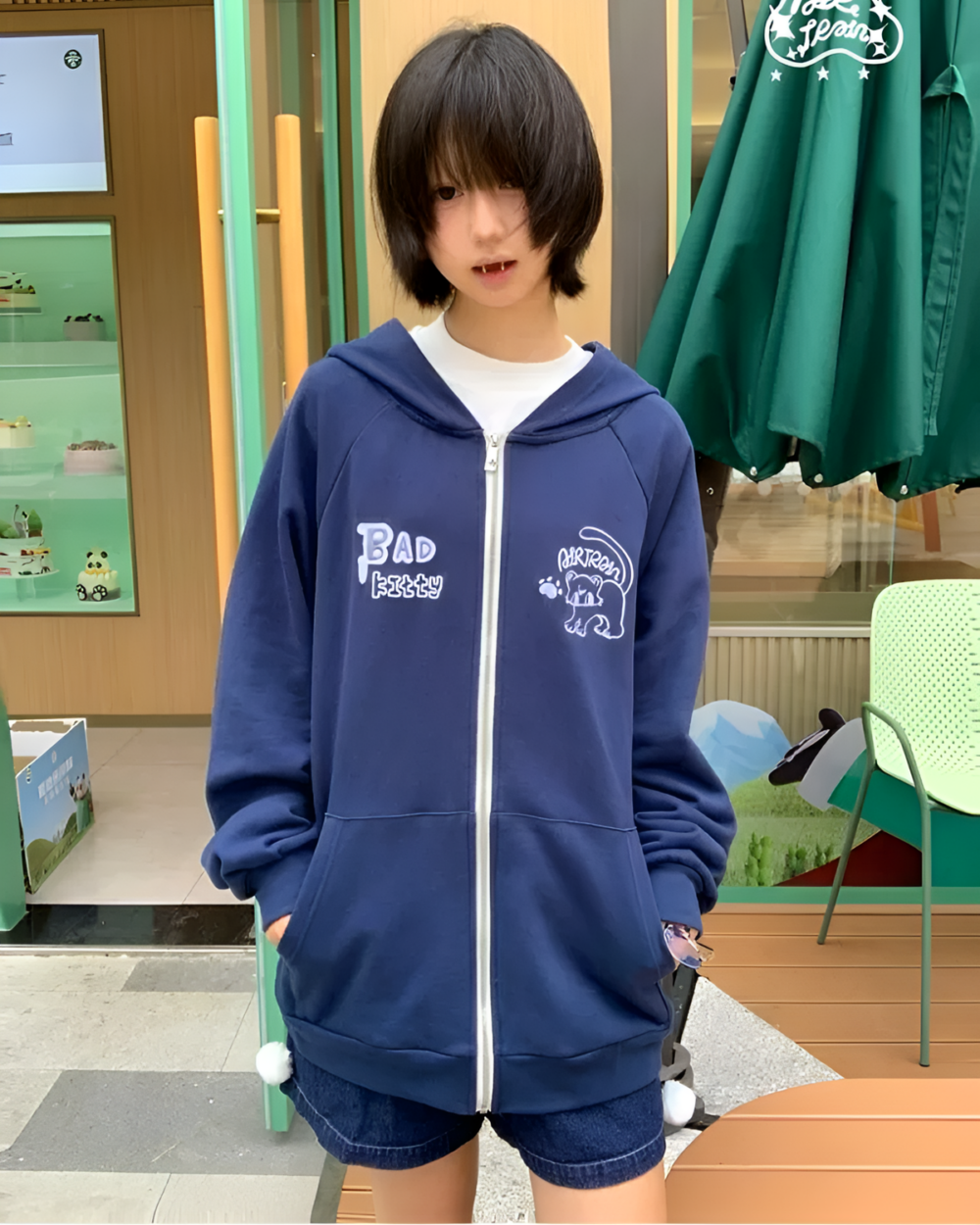 Navy Eared Hoodie featuring cartoon kitty design and 'Bad kitty' print.