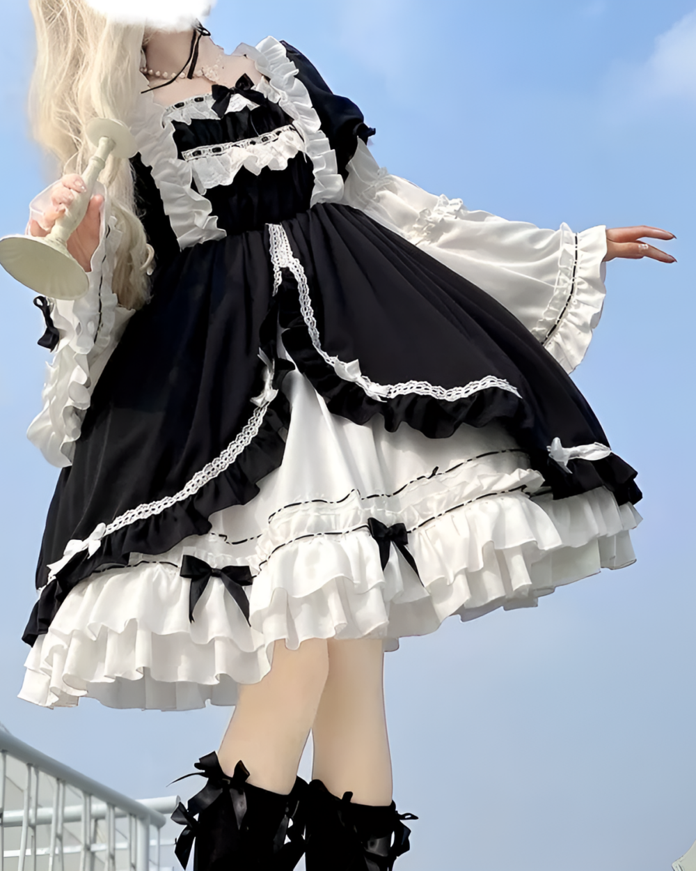 Black and white bowed maid dress with ruffles and lace details.
