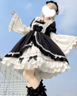 Black and white bowed maid dress with ruffles and lace details.
