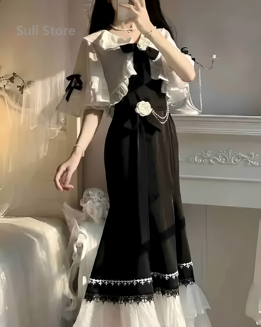 Black and white fairy midi dress with lace details, featuring a ruffled blouse and skirt.