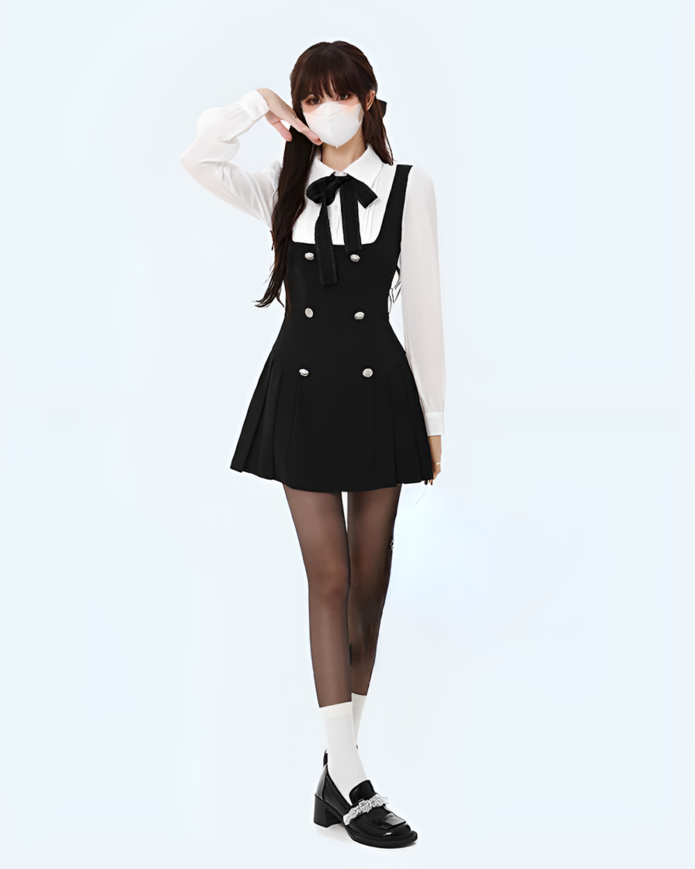 Woman wearing a black fake two-piece dress with a white shirt and tights.