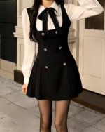 Black fake two-piece dress with a blazer and shirt, featuring double-button closure and pleated skirt.