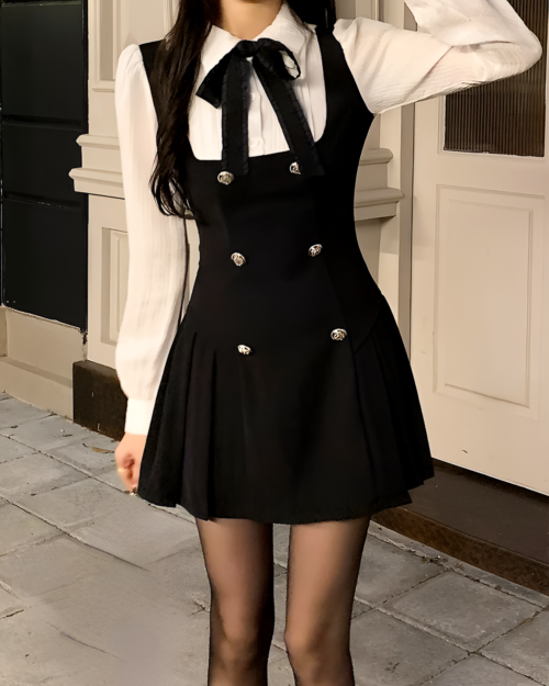 Black fake two-piece dress with a blazer and shirt, featuring double-button closure and pleated skirt.