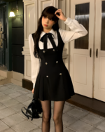 Black fake two-piece dress with a blouse and bib front closure.