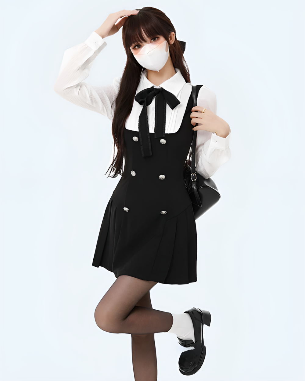 Black fake two-piece dress with a white shirt and bow tie, featuring a pleated skirt and button details.