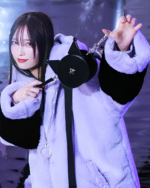 Faux Fur Hooded Coat - Kuromicore aesthetic, model wearing a black and white coat with a matching crossbody bag.