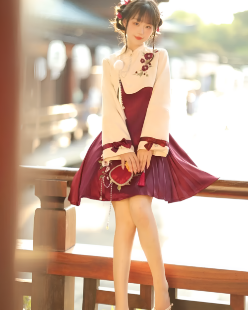 A person wearing a Flowery Wine Dress - Qi Lolita dress, featuring floral details and a layered skirt.