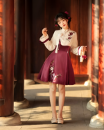 Woman wearing a floral Qi Lolita dress in a traditional setting.