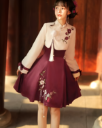 A burgundy and cream Qi Lolita dress with floral embroidery and pearl accents.