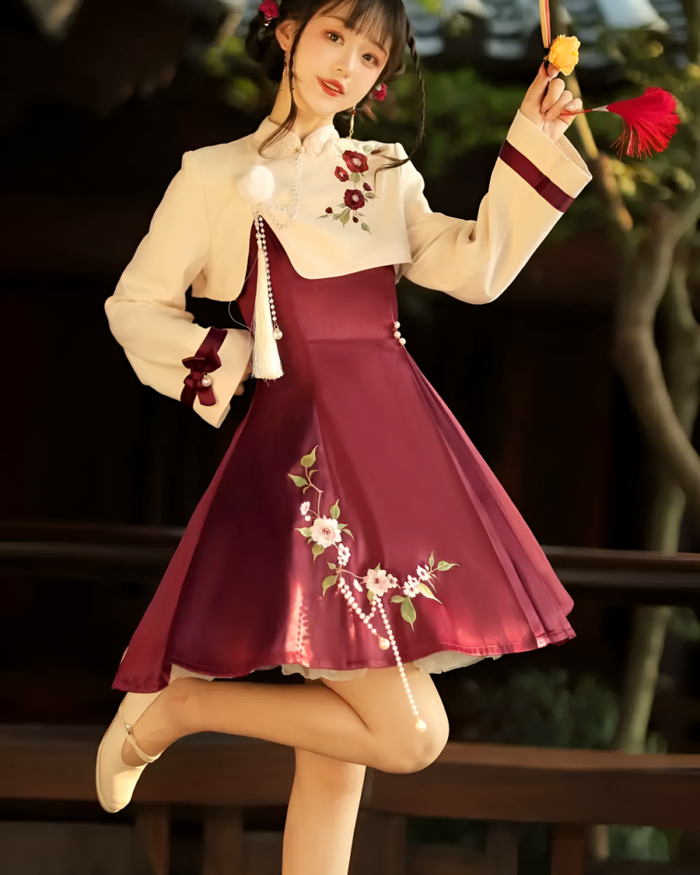 A burgundy Qi Lolita dress adorned with floral embroidery, featuring a white blouse and suspenders.
