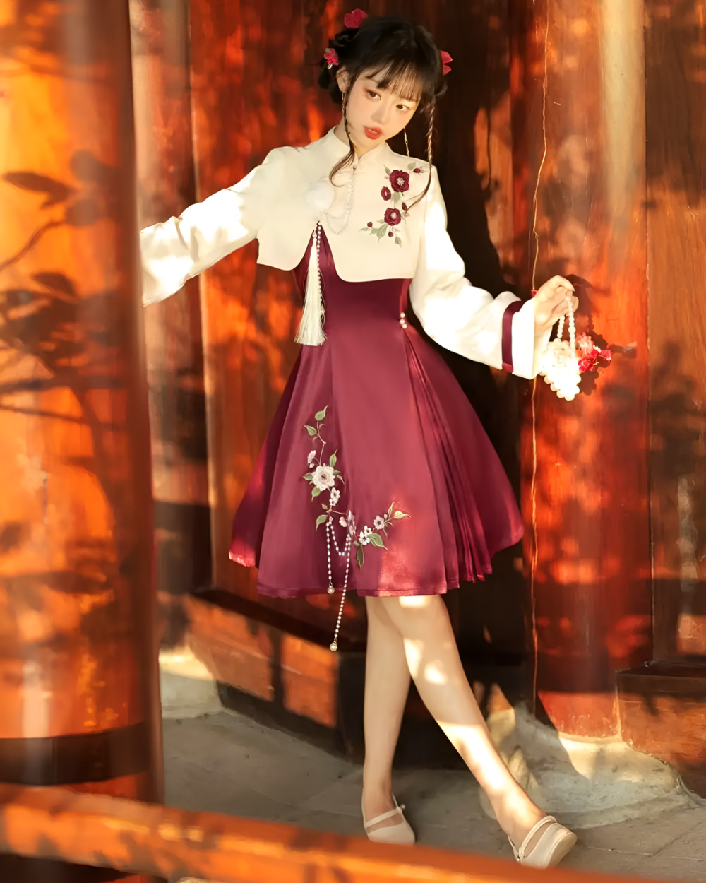 A burgundy Qi Lolita dress with floral embroidery and a matching jacket, featuring long sleeves and a delicate design.