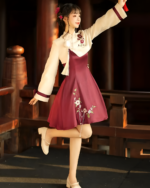 Qi Lolita dress in burgundy, featuring floral embroidery and a ruffled skirt, worn by a model.