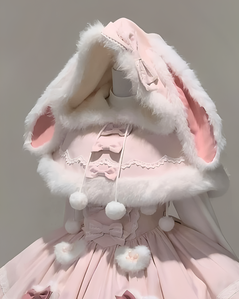 Close-up of a pink bunnycore dress with a fluffy hood and ears.