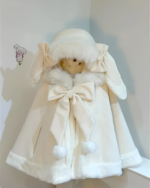 Close-up of a Fluffy Bunny Hooded Cloak, cream-colored with faux fur trim and bow.