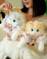 Two Fluffy Chonker Bags, plush cat backpacks, displayed with hands.