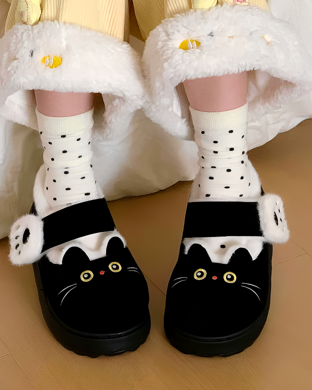Black and white Fluffy Mary Jane slippers with cat-ear details and faux fur trim.