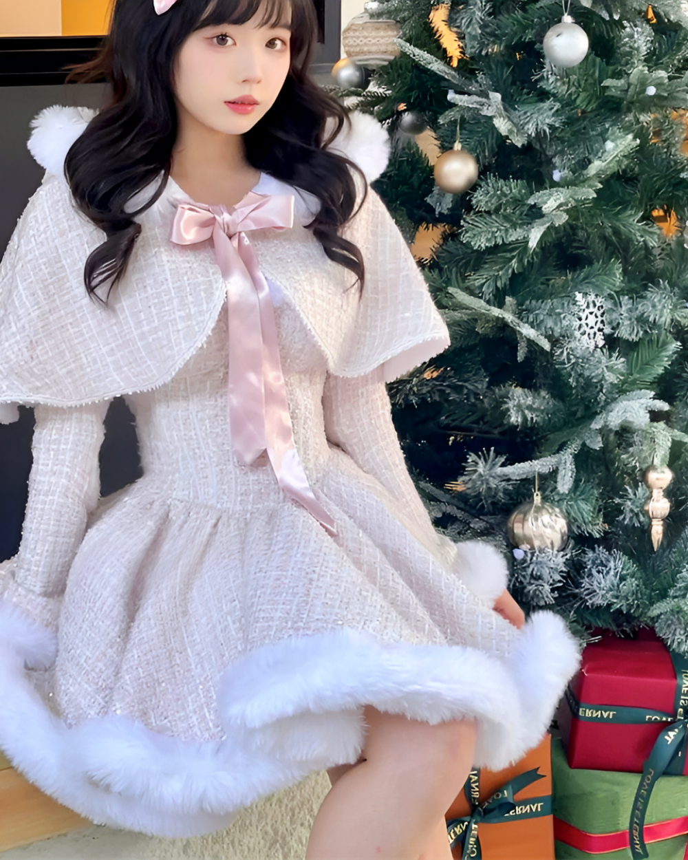 Model wearing a fluffy pink sweet lolita dress with white fur trim and a cape, styled for winter.