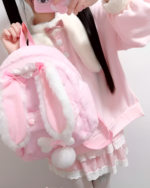 Pink rabbit eared backpack featuring plush details and a layered design by Jojifuku.