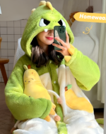 Person wearing a green dinosaur Fluffy Kigurumi robe while holding a phone. Part of the Fluffy Robes Collection.