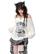 Model wearing a white top and a black and white gothic pleated skirt. The skirt has a plaid pattern.