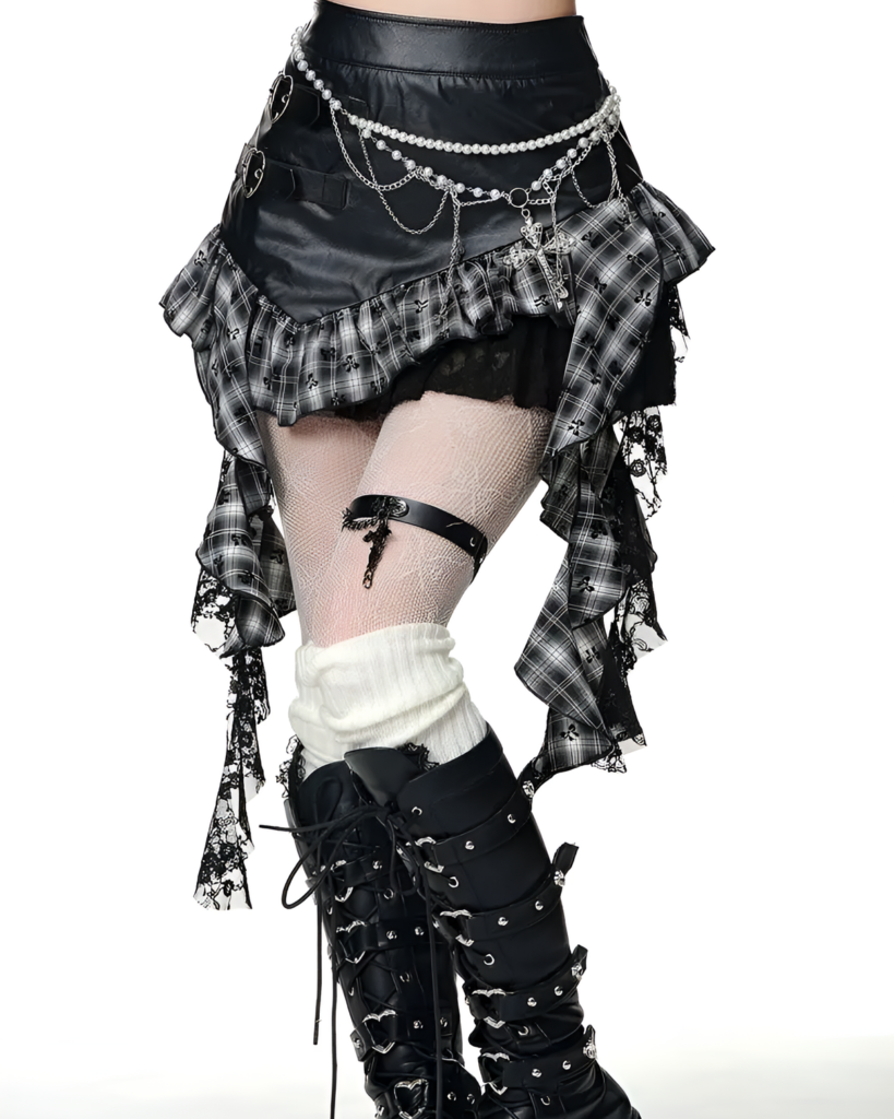 Model wearing a black and gray gothic pleated skirt with layered details and a chain belt, styled with boots and fishnet stockings.