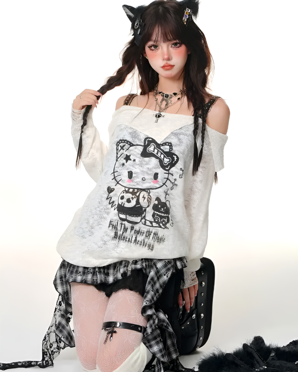 Model wearing a white top and a black and white checkered gothic pleated skirt with lace details.