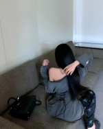 Woman wearing a Grunge-Style Dress, gray pants, and a handbag.