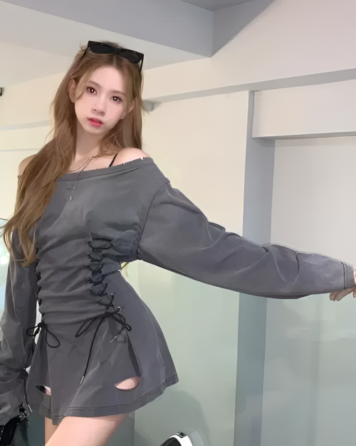 Woman wearing a gray Grunge-Style Dress with lace-up detailing and cutouts.