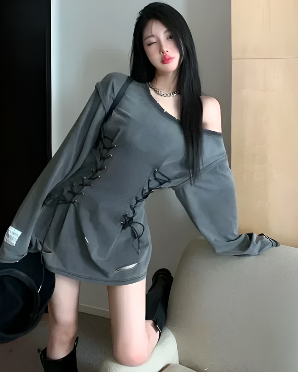 Woman wearing a Grunge-Style Dress with lacing details, off-shoulder style.